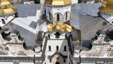 The roof of the shell-damaged Assumption Cathedral of the Lavra has been covered with film